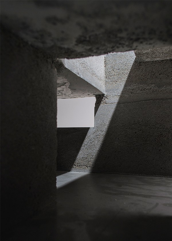 A view within the concrete spatial model with the upper aperture illuminating the space, studio substrata, Reinis Salins, Igors Malovickis
